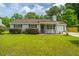 Attractive single-story home featuring a cozy front porch, gray siding, and a well-kept lawn at 505 Laurel Ridge Rd, North Charleston, SC 29418