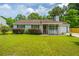 Inviting single-story home showcasing a charming front porch, neat landscaping, and a welcoming facade at 505 Laurel Ridge Rd, North Charleston, SC 29418