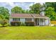 Charming single-story home with gray siding, landscaped yard, and cozy covered porch at 505 Laurel Ridge Rd, North Charleston, SC 29418