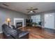Cozy living room with hardwood floors, a brick fireplace, and comfortable leather seating at 505 Laurel Ridge Rd, North Charleston, SC 29418