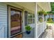 Cozy front porch featuring hanging plants, potted flowers, and a decorative wreath on the front door at 505 Laurel Ridge Rd, North Charleston, SC 29418