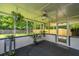 Inviting screened porch with a ceiling fan, natural light, and views of the surrounding greenery at 505 Laurel Ridge Rd, North Charleston, SC 29418