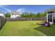 Spacious backyard with green grass, a wood fence and playset at 5222 American Holly Ln, Ladson, SC 29456
