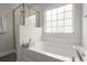Bright bathroom featuring a soaking tub with jets, a shower with glass doors, and a bright window at 5222 American Holly Ln, Ladson, SC 29456
