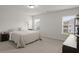 Bedroom with a queen bed, neutral decor, carpet floors, and bright windows for natural light at 5222 American Holly Ln, Ladson, SC 29456