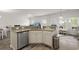 Kitchen with granite counters, stainless steel dishwasher, and an open view to dining and play areas at 5222 American Holly Ln, Ladson, SC 29456