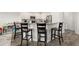 Kitchen island with barstool seating, white cabinetry and stainless steel appliances at 5222 American Holly Ln, Ladson, SC 29456