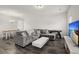 Spacious living room with hardwood floors, a large couch, a table and tv set at 5222 American Holly Ln, Ladson, SC 29456