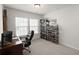 Bright office space with a desk, chair, natural light, and custom shelves for extensive beverage collection at 5222 American Holly Ln, Ladson, SC 29456