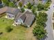 This aerial shot captures the home's backyard, landscaping, and proximity to other houses in the neighborhood at 5400 Turning Tide, North Charleston, SC 29420
