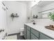 Bright bathroom features sage-colored cabinets, white walls, and a gold mirror at 5400 Turning Tide, North Charleston, SC 29420