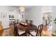 Inviting dining room with a dark wood table and chairs, hardwood floors, and cozy lighting at 5400 Turning Tide, North Charleston, SC 29420