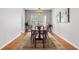 Elegant dining room with a long table, patterned rug, and natural light from the window at 5400 Turning Tide, North Charleston, SC 29420