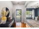 Inviting foyer with hardwood floors, a decorative console table, and views into the adjacent living spaces at 5400 Turning Tide, North Charleston, SC 29420