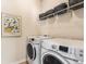 Laundry room with full-sized washer and dryer and open shelving at 5400 Turning Tide, North Charleston, SC 29420