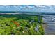 Aerial view of property showcasing waterfront location with serene marsh views in a residential community of Charleston, SC at 5692 Barbary Coast Rd, Hollywood, SC 29449