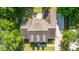 Aerial perspective of roof and landscaped lawn showcases a home's backyard patio at 5692 Barbary Coast Rd, Hollywood, SC 29449