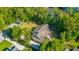 Aerial view showcases lush landscaped yard and roof of home in residential neighborhood at 5692 Barbary Coast Rd, Hollywood, SC 29449