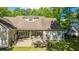 Aerial view of a beautiful backyard with a patio featuring an outdoor seating area, fire pit and manicured lawn at 5692 Barbary Coast Rd, Hollywood, SC 29449