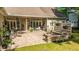 Lush backyard with a covered patio, stone fire pit, and manicured lawn perfect for outdoor activities at 5692 Barbary Coast Rd, Hollywood, SC 29449