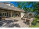 Expansive backyard with a covered patio, fire pit area, and well-maintained lawn at 5692 Barbary Coast Rd, Hollywood, SC 29449