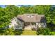 Aerial view of a house showcasing an outdoor patio seating area, fire pit and a well-maintained lawn at 5692 Barbary Coast Rd, Hollywood, SC 29449