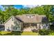 Aerial view of home featuring a backyard with a patio, outdoor seating, a fire pit and lush landscaping at 5692 Barbary Coast Rd, Hollywood, SC 29449