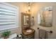 A powder room featuring custom mirror, vanity, and lighting at 5692 Barbary Coast Rd, Hollywood, SC 29449
