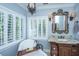 Luxurious bathroom featuring a freestanding tub, elegant vanity, and natural light at 5692 Barbary Coast Rd, Hollywood, SC 29449