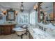 Spa-like bathroom with dual vanities, a freestanding tub, and decorative lighting at 5692 Barbary Coast Rd, Hollywood, SC 29449