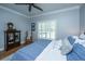 Bedroom with a ceiling fan, shuttered windows and a vintage cabinet display at 5692 Barbary Coast Rd, Hollywood, SC 29449