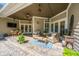 Charming covered patio with comfortable seating, stylish decor, and a ceiling fan for added comfort at 5692 Barbary Coast Rd, Hollywood, SC 29449
