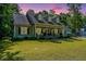 Charming home with a welcoming front porch, green lawn, and meticulous landscaping at 5692 Barbary Coast Rd, Hollywood, SC 29449