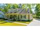 Inviting home with a covered front porch, dormer windows, and a well-manicured lawn at 5692 Barbary Coast Rd, Hollywood, SC 29449