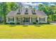 Beautiful home with a welcoming front porch, well-maintained landscaping, and classic design features at 5692 Barbary Coast Rd, Hollywood, SC 29449