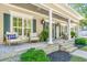 Inviting front porch with comfortable seating and manicured landscaping at 5692 Barbary Coast Rd, Hollywood, SC 29449