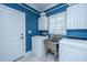 Bright laundry room featuring blue-painted beadboard and new appliances at 5692 Barbary Coast Rd, Hollywood, SC 29449