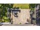 Aerial view of stamped concrete patio with a fire pit, outdoor kitchen and a fence with flower boxes, creating a cozy outdoor space at 5692 Barbary Coast Rd, Hollywood, SC 29449