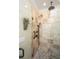 Walk-in shower with pebble flooring and travertine tile, including a hand-held shower head at 5692 Barbary Coast Rd, Hollywood, SC 29449
