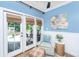 Bright sitting area with French doors, stylish chair, and charming decor at 5692 Barbary Coast Rd, Hollywood, SC 29449