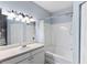Bright bathroom with a white vanity, bathtub, shower, and white tile at 60 Fenwick # 936, Johns Island, SC 29455