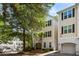 Two-story residential building exterior with neutral siding, black shutters and trees at 60 Fenwick # 936, Johns Island, SC 29455