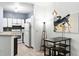 Cozy kitchen with white appliances, and a dark wood dining table with stool seating at 60 Fenwick # 936, Johns Island, SC 29455
