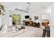 Bright living room with a white couch, fireplace, ceiling fan, and sliding glass doors to the balcony at 60 Fenwick # 936, Johns Island, SC 29455