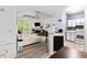 Bright living room with a modern kitchen, fireplace, and access to the balcony at 60 Fenwick # 936, Johns Island, SC 29455