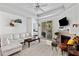 Bright living room features a white couch, fireplace, and access to the balcony at 60 Fenwick # 936, Johns Island, SC 29455