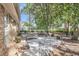 Spacious backyard offers a serene setting with mature trees and a patio with outdoor furniture at 615 Fairington Dr, Summerville, SC 29485