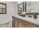 Bathroom vanity featuring dark cabinets, double sinks, granite counters and a large mirror at 615 Fairington Dr, Summerville, SC 29485