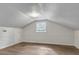 A cozy bedroom with a unique angled ceiling, paneled walls, and wood-look flooring at 615 Fairington Dr, Summerville, SC 29485