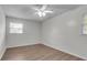 Bright bedroom featuring a ceiling fan, wood floors, and two windows at 615 Fairington Dr, Summerville, SC 29485